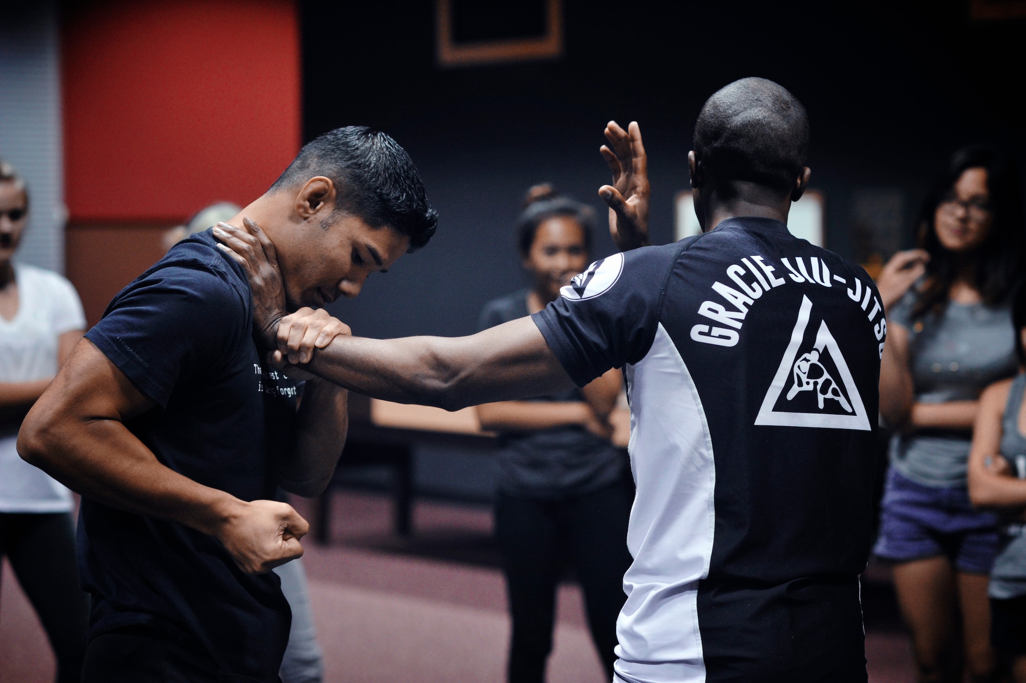 Master Sgt. Samnang Lay, left, and Maj. Tyrone Bess demonstrate self-defense techniques during a Gracie Jiu-Jitsu Defense Systems course at Yokota Air Base, Japan, July 23, 2016. The Gracie Defense Systems is a program specifically designed to increase awareness and reduce the frequency of sexual assaults. (U.S. Air Force photo by Senior Airman Delano Scott/Released)