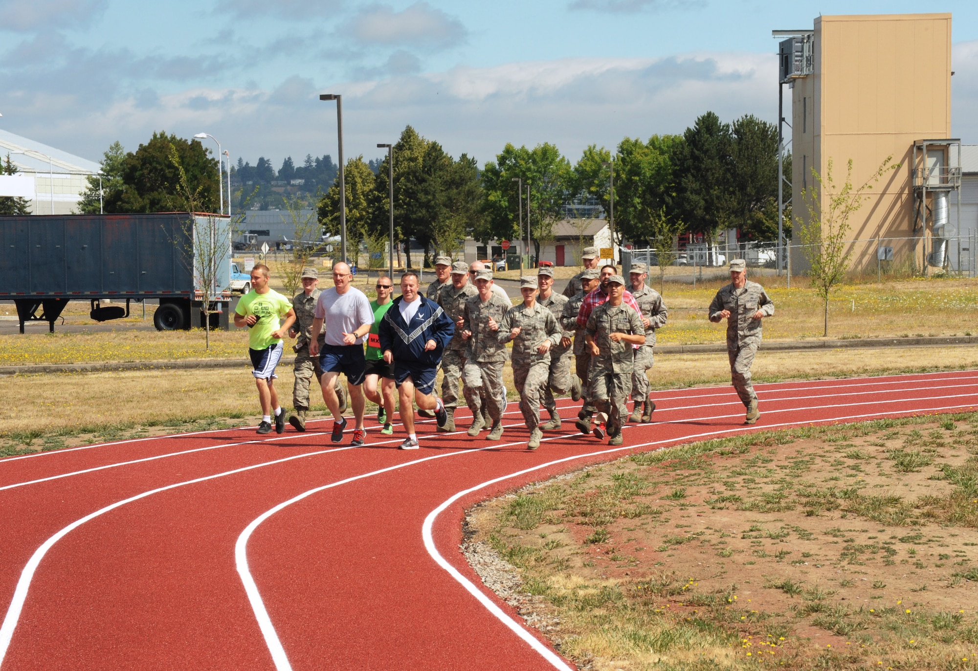 Oregon Air National Guard Col. Paul Fitzgerald, 142nd Fighter Wing commander and Chief Master Sgt. Chris Roper, 142nd Fighter Wing command chief, lead a group of Airmen and base staff during a ceremonial first lap as part of the official opening of the new base track, Portland Air National Guard Base, Ore., July 26, 2016. (U.S. Air National Guard photo by Tech. Sgt. John Hughel, 142nd Fighter Wing Public Affairs/Released)