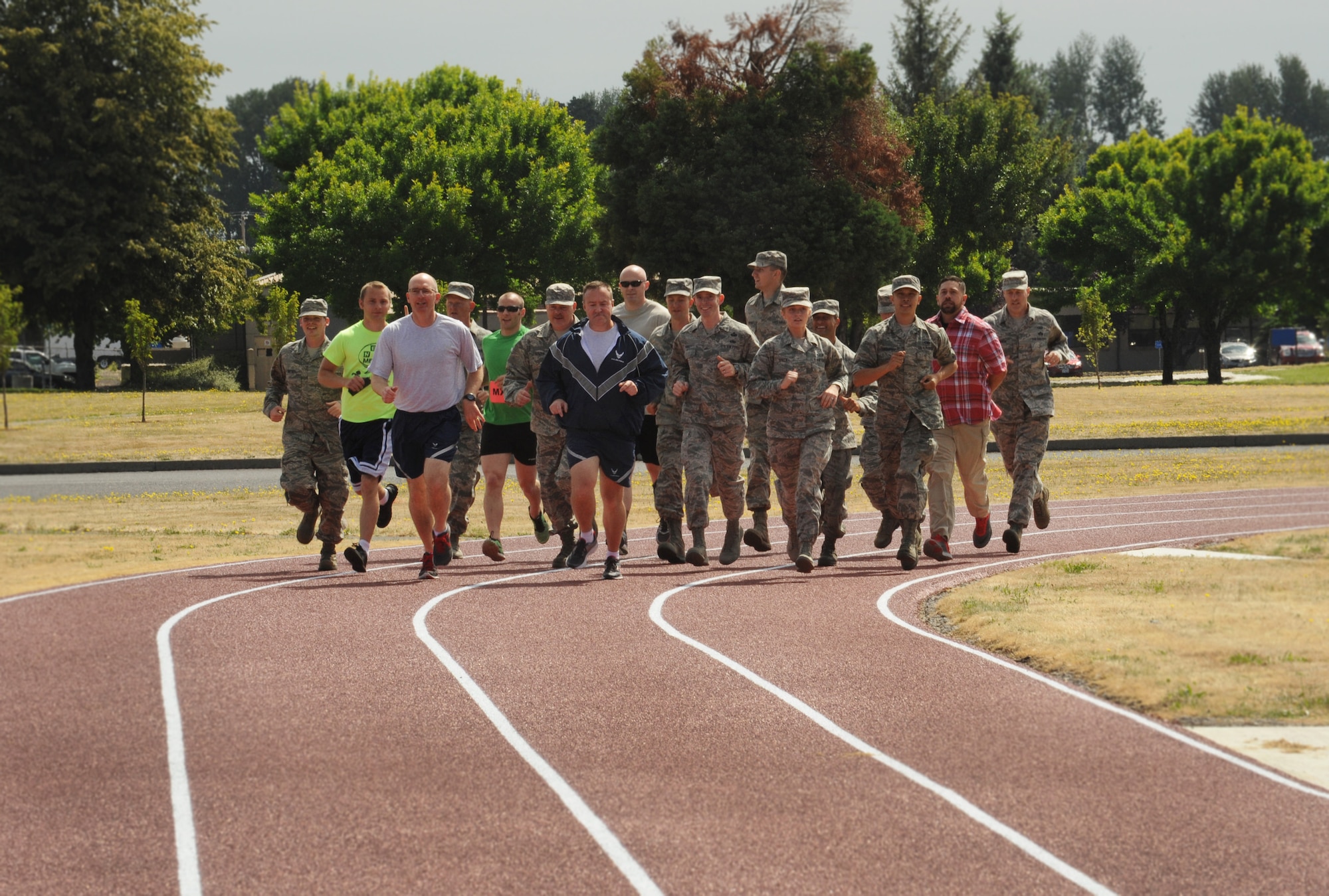 Oregon Air National Guard Col. Paul Fitzgerald, 142nd Fighter Wing commander and Chief Master Sgt. Chris Roper, 142nd Fighter Wing command chief, lead a group of Airmen and base staff during a ceremonial first lap as part of the official opening of the new base track, Portland Air National Guard Base, Ore., July 26, 2016. (U.S. Air National Guard photo by Tech. Sgt. John Hughel, 142nd Fighter Wing Public Affairs/Released)