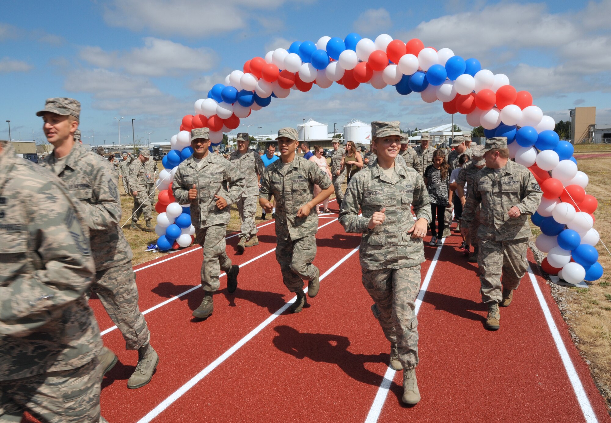 Oregon Air National Guard Airmen from the 142nd Fighter Wing run on the new base track during a ceremonial first lap as part of the official opening for the project,  Portland Air National Guard Base, Ore., July 26, 2016. (U.S. Air National Guard photo by Tech. Sgt. John Hughel, 142nd Fighter Wing Public Affairs/Released)