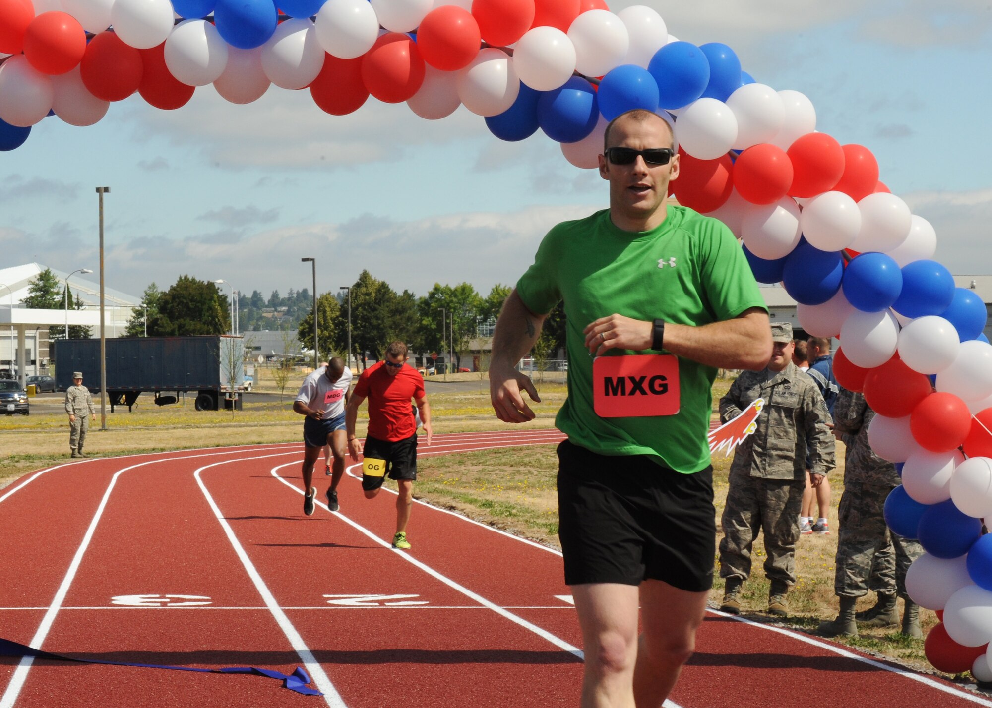 Oregon Air National Guard Staff Sgt. Alan Plank, assigned to the 142nd Fighter Wing Maintenance Group, wins the inaugural first race, followed by Tech. Sgt. Justin Comfort and Staff Sgt. Breland Reed on the new track at the Portland Air National Guard Base, Ore., July 26, 2016. (U.S. Air National Guard photo by Tech. Sgt. John Hughel, 142nd Fighter Wing Public Affairs/Released)