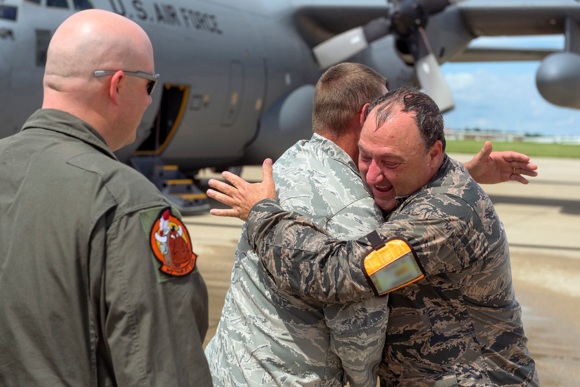 U.S. Air Force Col. Barton Welker, the commander of the 182nd Maintenance Group, Illinois Air National Guard, embraces a colleague after his “fini flight” at the 182nd Airlift Wing in Peoria, Ill., July 25, 2016. Welker is scheduled to retire Aug. 1 after 34 years of military service. (U.S. Air National Guard photo by Staff Sgt. Lealan Buehrer) (Identification badge was digitally obscured for OPSEC.)