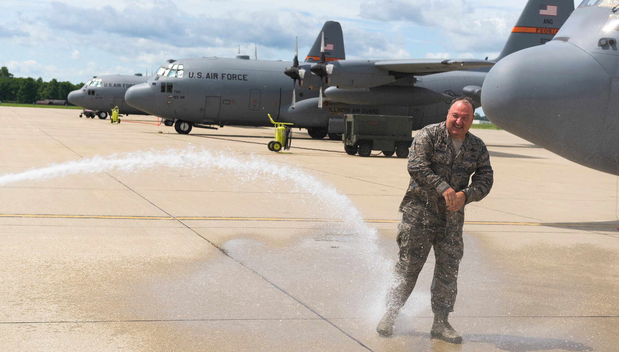 U.S. Air Force Col. Barton Welker, the commander of the 182nd Maintenance Group, Illinois Air National Guard, is doused with water after his “fini flight” at the 182nd Airlift Wing in Peoria, Ill., July 25, 2016. Welker is scheduled to retire Aug. 1 after 34 years of military service. (U.S. Air National Guard photo by Staff Sgt. Lealan Buehrer)