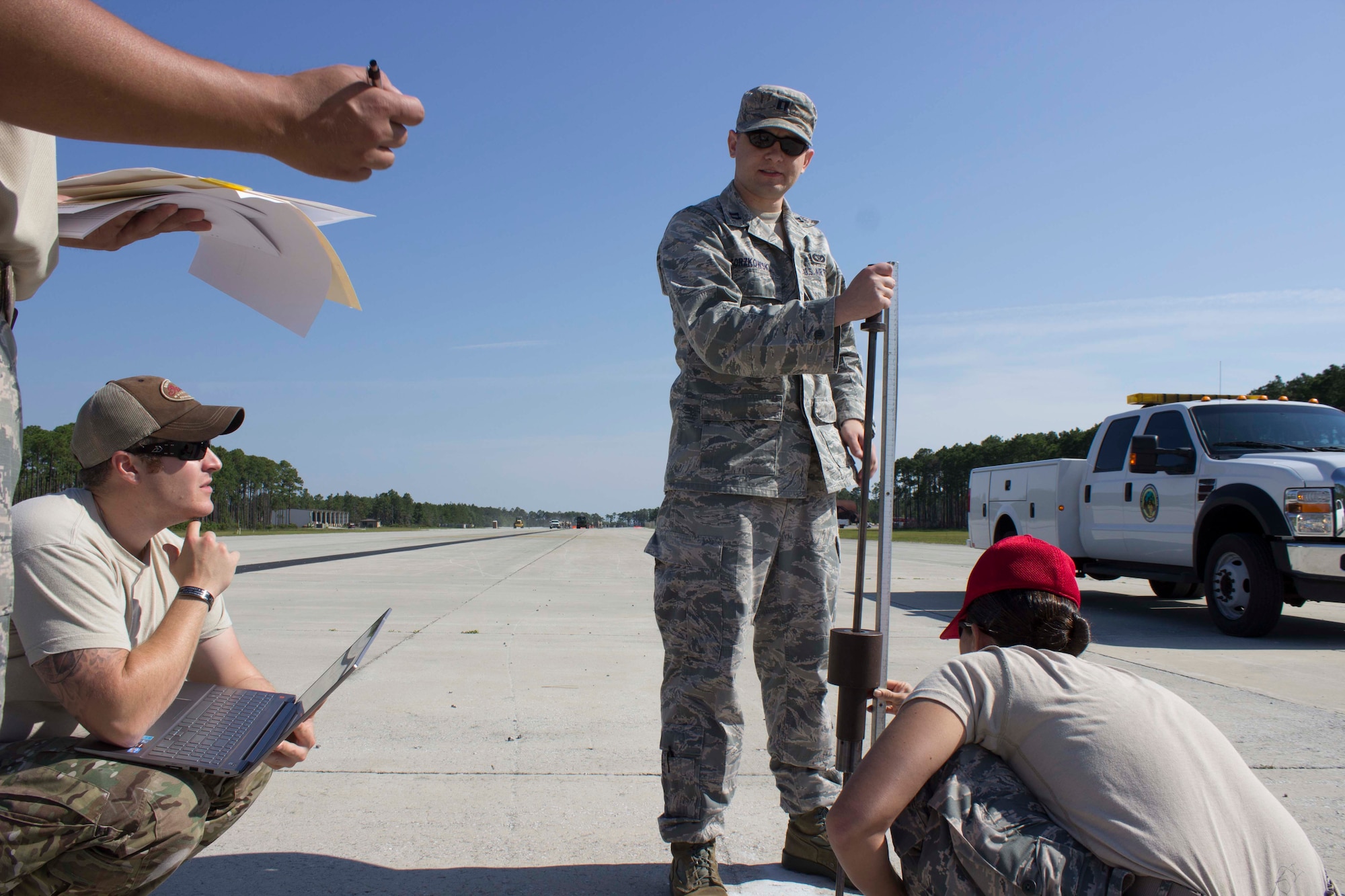Joint force contingency airfield pavement evaluation students determine the strength of the soil beneath the airfield pavement using a Dynamic Cone Penetrometer during a field training day at the Silver Flag site at Tyndall Air Force Base, Florida. (U.S. Air Force Photo/Susan Lawson)