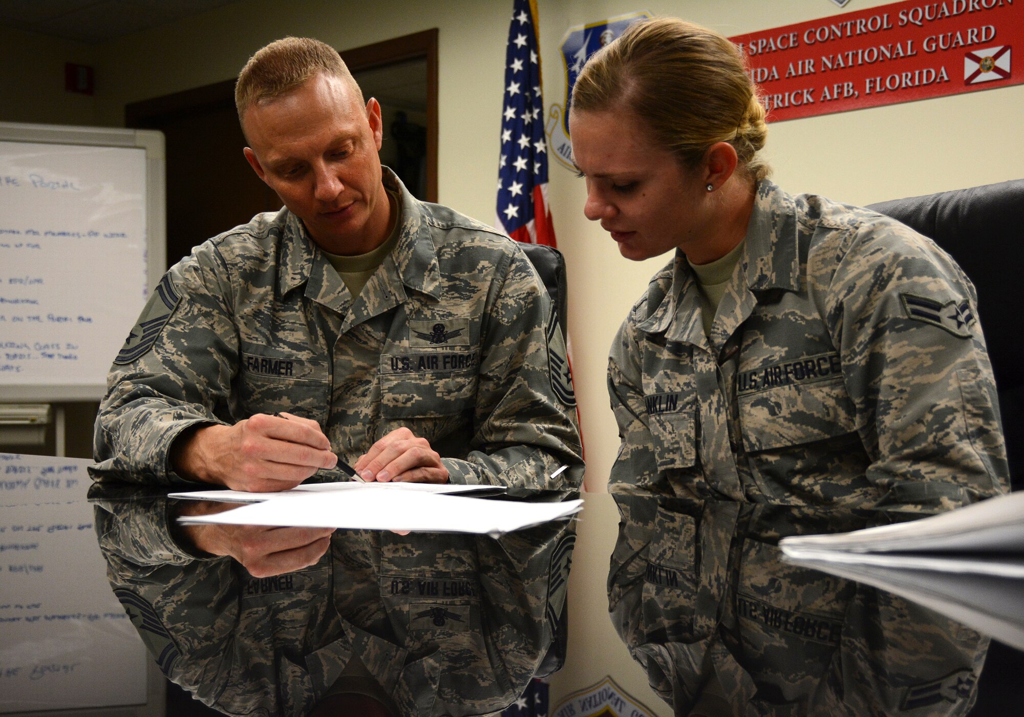 Senior Master Sgt. Mark Farmer, a space systems operations superintendent assigned to the 114th Space Control Squadron at Patrick AFB, Florida, mentors an Airman in his unit June 3, 2016. Farmer is the Air National Guard's 2016 Outstanding Senior NCO of the Year and one of the U.S. Air Force's 12 Outstanding Airmen of the Year. (U.S. Air National Guard photo by Tech. Sgt. William Buchanan, 125th Fighter Wing Public Affairs)