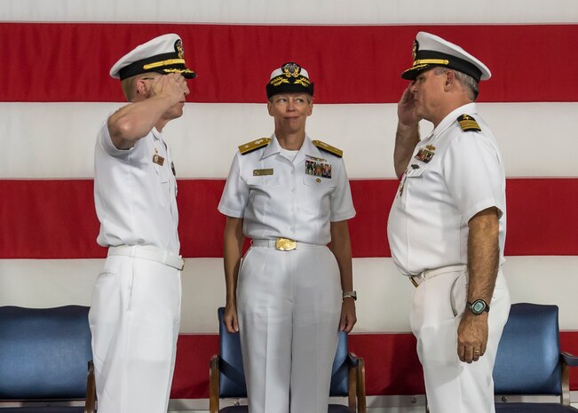 U.S. Navy Capt. Robert Hudson, left, takes command of Naval Support Activity Charleston with a salute to his predecessor Capt. Timothy Sparks. Rear Admiral Mary Jackson, Navy Region Southeast commander, observes during a change of command ceremony, July 21, 2016 aboard the USS Yorktown, Charleston, S.C. Hudson previously served as the Nuclear Power Training Unit Charleston commander. Sparks is retiring after 38 years of military service. (U.S. Air Force photo/Staff Sgt. Jared Trimarchi) 