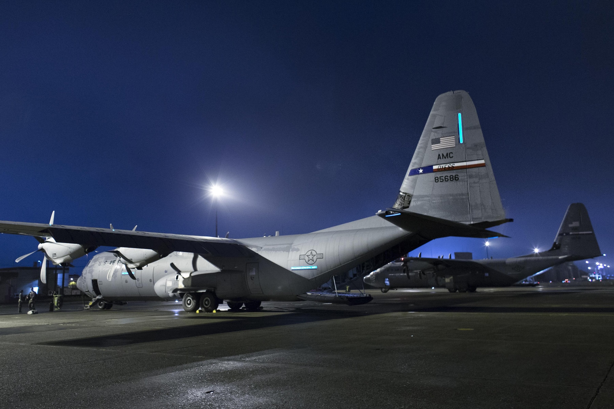 Two C-130J Super Hercules sit on the flightline at Yokota Air Base, Japan, July 21, 2016, during a training flight. Three C-130Js from Dyess Air Force Base, Texas, traveled to Yokota to aid in transition from C-130Hs to C-130Js. Fourteen C-130Js are scheduled to start replacing Yokota’s C-130Hs later this year, which have been in service since 1974. (U.S. Air Force photo by Yasuo Osakabe/Released)  
