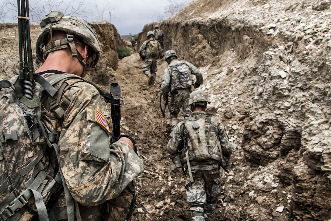 Soldiers move through a trench during a combined arms live-fire exercise as part of Africa Readiness Training 16 in Thies, Senegal, July 25, 2016. The soldiers are assigned to the 3rd Infantry Division's Bravo Company, 1st Battalion, 30th Infantry Regiment, 2nd Infantry Brigade Combat Team. Army photo by Spc. Craig Philbrick