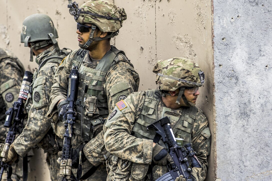 Soldiers check their surroundings during live-fire training at the Joint Readiness Training Center in Fort Polk, La., July 25, 2016. The soldiers are assigned to New York Army National Guard's Company C, 1st Battalion, 69th Infantry Regiment. Army National Guard photo by Sgt. Harley Jelis
