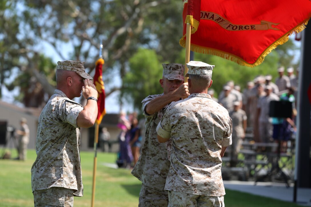 Lt. Gen. David H. Berger, the outgoing commanding general of I Marine Expeditionary Force, passes the unit colors to Lt. Gen. Lewis A. Craparotta during a change of command ceremony at Camp Pendleton July 27, 2016. Berger is set to become the next U. S. Marine Forces Pacific commander in August of 2016.  (U.S. Marine Corps photo by Cpl. Garrett White/ RELEASED)