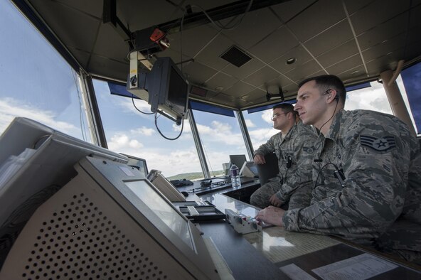 U.S. Air Force Staff Sgt. Louis Kelley and Senior Airman Aaron Funari, 18th Operations Support Squadron air traffic controllers, look out at the flightline July 21, 2016, at Kadena Air Base, Japan. As the Air Force’s largest combat wing, Kadena's airfield is one of the busiest in the Air Force. The operations of the 18th OSS ATC Airmen keep processes running smoothly. (U.S. Air Force photo by Airman 1st Class Lynette M. Rolen) 