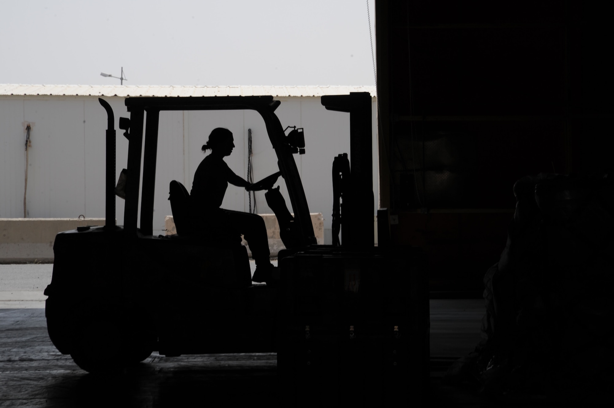 An Airman from the 386th Expeditionary Logistics Readiness Squadron aerial port flight operates a forklift July 21, 2016 at an undisclosed location in Southwest Asia. The 386 ELRS is home to the busiest aerial port in Southwest Asia. (U.S. Air Force photo/Senior Airman Zachary Kee)