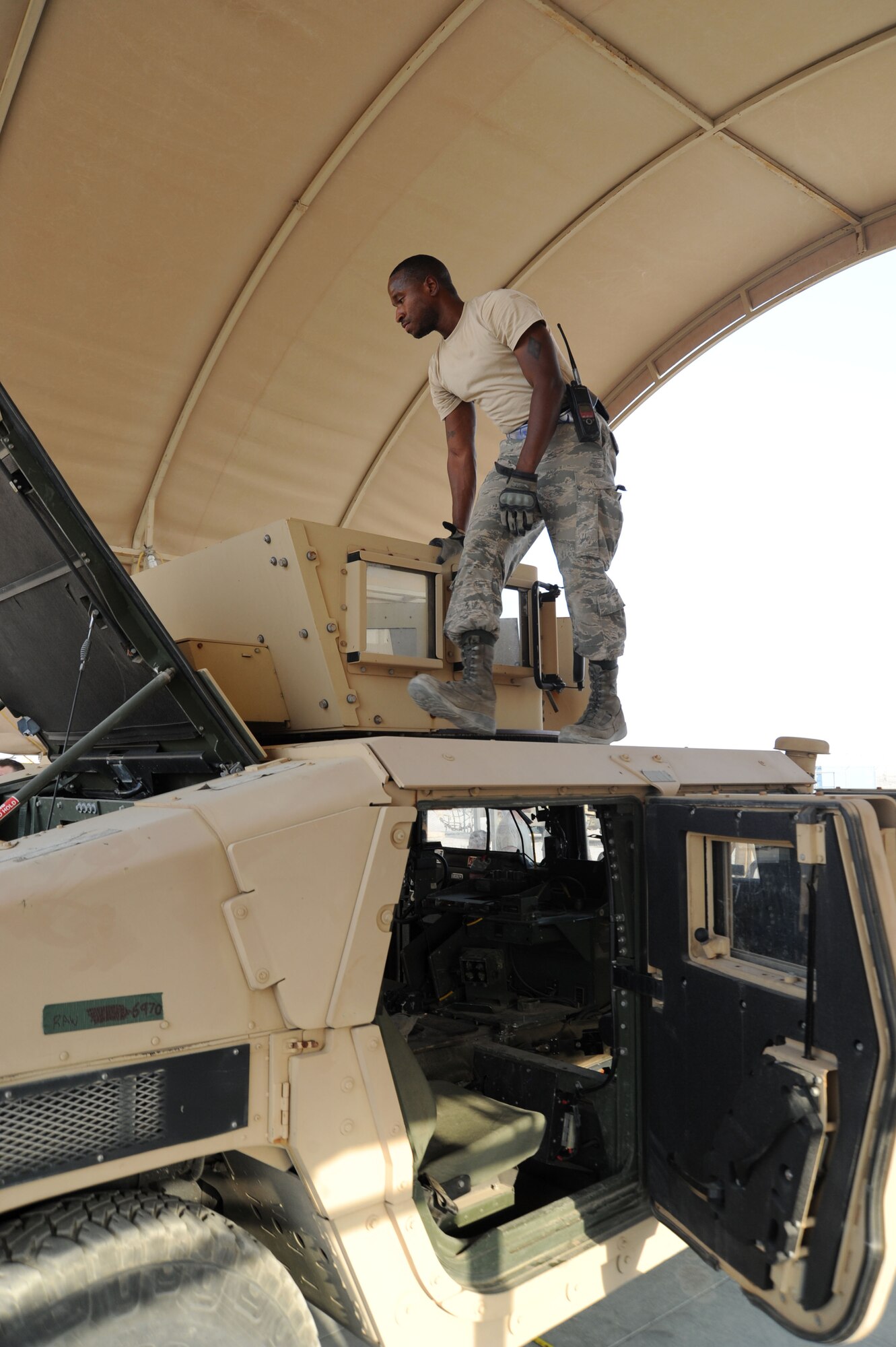Senior Airman Daniel Gardner, 386th Expeditionary Logistics Readiness Squadron special handling technician, inspects a Humvee July, 21, 2016 at an undisclosed location in Southwest Asia. The special handling section of the 386 ELRS aerial port flight is responsible for performing joint inspections, which allows everything that passes inspection to be gained into the port. (U.S. Air Force photo/Senior Airman Zachary Kee)