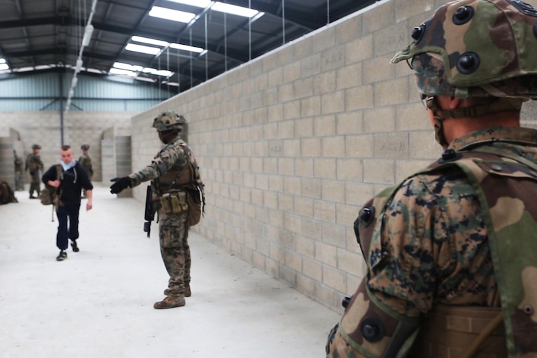 U.S. Marine Corps Lance Cpl. Jacob C. Gross, (right), a rifleman, with Bravo company, 1st Battalion, 8th Marine Regiment, Special Purpose Marine Air-Ground Task Force-Crisis Response-Africa observes simulated civilians move to a safe and secure location during a Non-combatant evacuation operation exercise hosted by French Army Center for Urban Combat Training instructors aboard Camp Sissonne, France, June 21, 2016. SPMAGTF-CR-AF Marines trained alongside a company of French Army soldiers, integrating their skills and resources to form an effective battle plan, similar to what they may face in the event of a future crisis. (U.S. Marine Corps photo by Sgt. Kassie L. McDole/Released) 