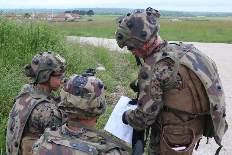 U.S. Marine Corps Cpl. Dylan P. Hartzoge, (right), a squad leader with Bravo company, 1st Battalion, 8th Marine Regiment, Special Purpose Marine Air-Ground Task Force-Crisis Response-Africa briefs a course of action to Marines within his squad during a Non-combatant evacuation operation exercise hosted by French Army Center for Urban Combat Training instructors aboard Camp Sissonne, France, June 21, 2016. SPMAGTF-CR-AF Marines trained alongside a company of French Army soldiers, integrating their skills and resources to form an effective battle plan, similar to what they may face in the event of a future crisis. (U.S. Marine Corps photo by Sgt. Kassie L. McDole/Released) 