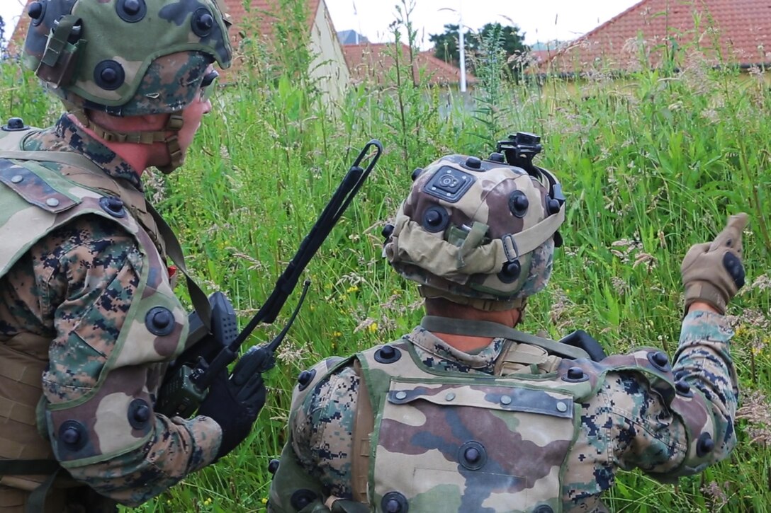 U.S. Marine Corps Lance Cpl. William T. Wallace, (right), a team leader, discusses his course of action with Cpl. Dylan P. Hartzoge, a squad leader, both with Bravo company, 1st Battalion, 8th Marine Regiment, Special Purpose Marine Air-Ground Task Force-Crisis Response-Africa during a Non-combatant evacuation operation exercise hosted by French Army Center for Urban Combat Training instructors aboard Camp Sissonne, France, June 21, 2016. SPMAGTF-CR-AF Marines trained alongside a company of French Army soldiers, integrating their skills and resources to form an effective battle plan, similar to what they may face in the event of a future crisis. (U.S. Marine Corps photo by Sgt. Kassie L. McDole/Released) 