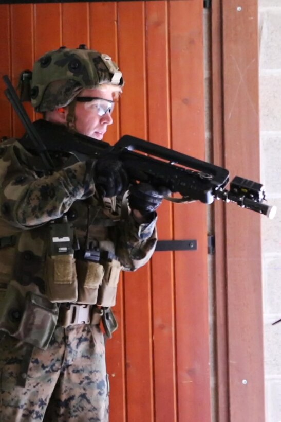 U.S. Marine Corps Cpl. Dylan P. Hartzoge, a squad leader with Bravo company, 1st Battalion, 8th Marine Regiment, Special Purpose Marine Air-Ground Task Force-Crisis Response-Africa looks around a corner for a simulated enemy during a Non-combatant evacuation operation exercise hosted by French Army Center for Urban Combat Training instructors aboard Camp Sissonne, France, June 21, 2016. SPMAGTF-CR-AF Marines trained alongside a company of French Army soldiers, integrating their skills and resources to form an effective battle plan, similar to what they may face in the event of a future crisis. (U.S. Marine Corps photo by Sgt. Kassie L. McDole/Released) 