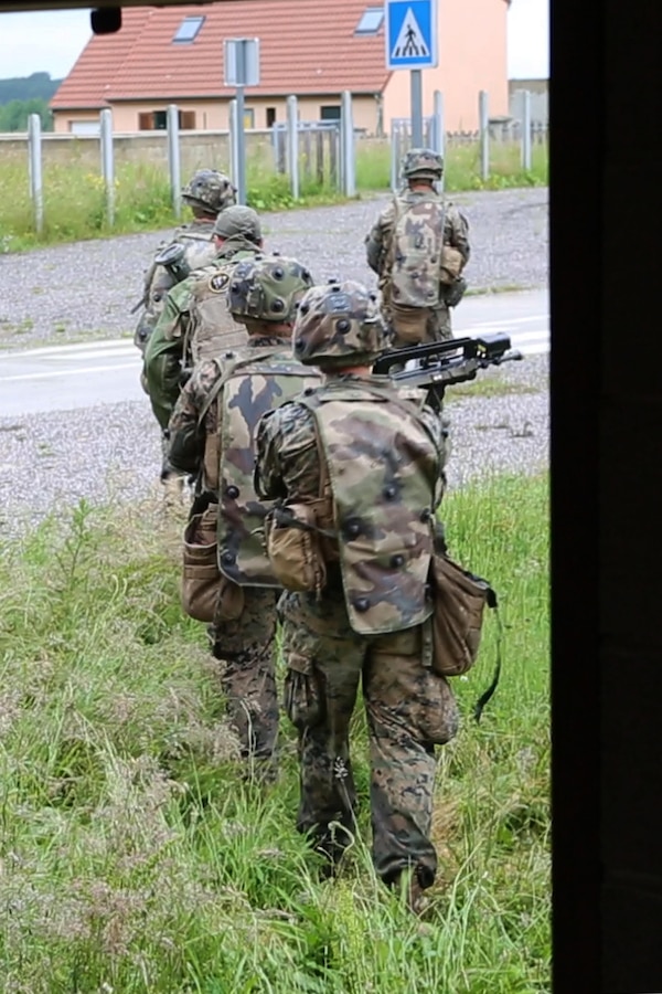 U.S. Marines with Bravo company, 1st Battalion, 8th Marine Regiment, Special Purpose Marine Air-Ground Task Force-Crisis Response-Africa search for simulated enemy during a Non-combatant evacuation operation exercise hosted by French Army Center for Urban Combat Training instructors aboard Camp Sissonne, France, June 21, 2016. SPMAGTF-CR-AF Marines trained alongside a company of French Army soldiers, integrating their skills and resources to form an effective battle plan, similar to what they may face in the event of a future crisis. (U.S. Marine Corps photo by Sgt. Kassie L. McDole/Released) 