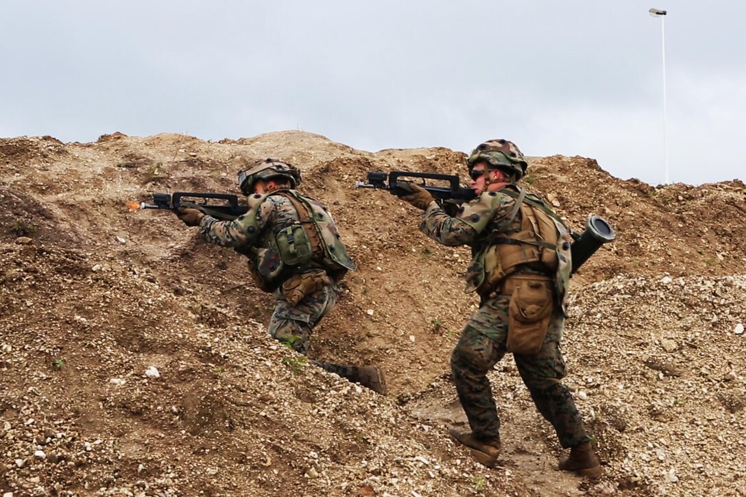 U.S. Marine Corps Lance Cpl. William T. Wallace, (left), a team leader and Lance Cpl. Chase C. Lawrence, (right), a rifleman, both with Bravo company, 1st Battalion, 8th Marine Regiment, Special Purpose Marine Air-Ground Task Force-Crisis Response-Africa fire their French FAMAS F1 at a simulated enemy during a Non-combatant evacuation operation exercise hosted by French Army Center for Urban Combat Training instructors aboard Camp Sissonne, France, June 21, 2016. SPMAGTF-CR-AF Marines trained alongside a company of French Army soldiers, integrating their skills and resources to form an effective battle plan, similar to what they may face in the event of a future crisis. (U.S. Marine Corps photo by Sgt. Kassie L. McDole/Released)