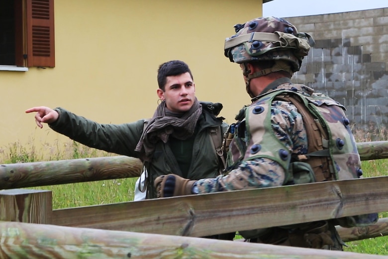 U.S. Marine Corps Lance Cpl. William T. Wallace, a team leader with Bravo company, 1st Battalion, 8th Marine Regiment, Special Purpose Marine Air-Ground Task Force-Crisis Response-Africa speaks with a simulated civilian during a Non-combatant evacuation operation exercise hosted by French Army Center for Urban Combat Training instructors aboard Camp Sissonne, France, June 21, 2016. SPMAGTF-CR-AF Marines trained alongside a company of French Army soldiers, integrating their skills and resources to form an effective battle plan, similar to what they may face in the event of a future crisis. (U.S. Marine Corps photo by Sgt. Kassie L. McDole/Released) 