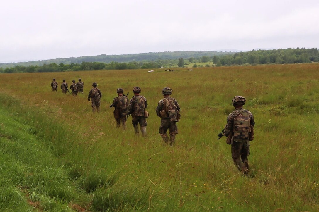 U.S. Marines with Bravo company, 1st Battalion, 8th Marine Regiment, Special Purpose Marine Air-Ground Task Force-Crisis Response-Africa search for simulated enemy during a Non-combatant evacuation operation exercise hosted by French Army Center for Urban Combat Training instructors aboard Camp Sissonne, France, June 21, 2016. SPMAGTF-CR-AF Marines trained alongside a company of French Army soldiers, integrating their skills and resources to form an effective battle plan, similar to what they may face in the event of a future crisis. (U.S. Marine Corps photo by Sgt. Kassie L. McDole/Released)