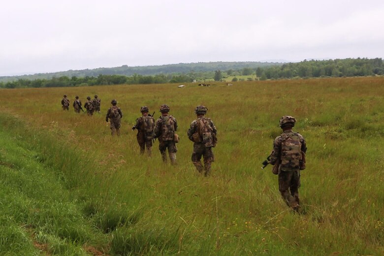 U.S. Marines with Bravo company, 1st Battalion, 8th Marine Regiment, Special Purpose Marine Air-Ground Task Force-Crisis Response-Africa search for simulated enemy during a Non-combatant evacuation operation exercise hosted by French Army Center for Urban Combat Training instructors aboard Camp Sissonne, France, June 21, 2016. SPMAGTF-CR-AF Marines trained alongside a company of French Army soldiers, integrating their skills and resources to form an effective battle plan, similar to what they may face in the event of a future crisis. (U.S. Marine Corps photo by Sgt. Kassie L. McDole/Released)