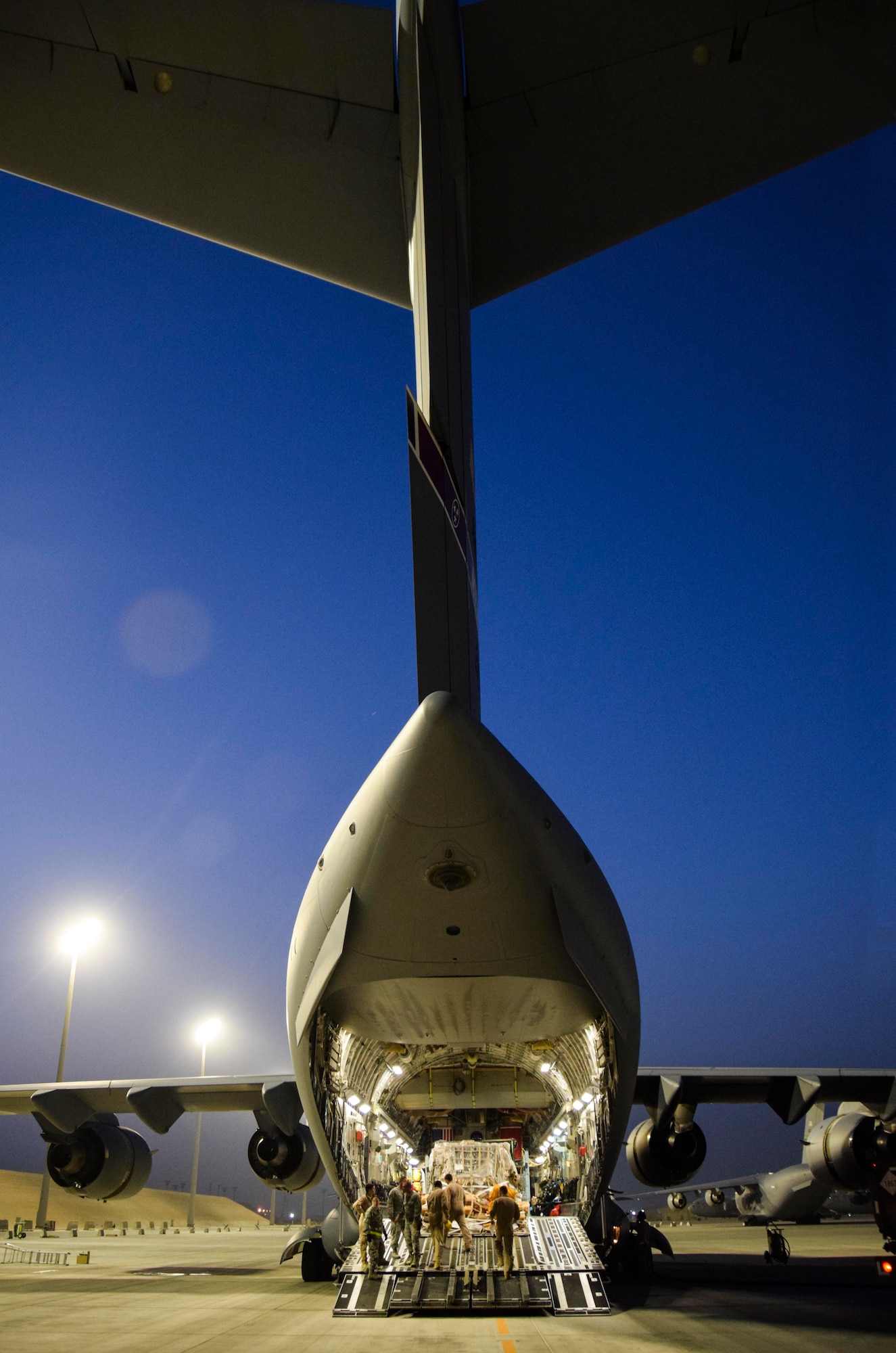 A C-17 Globemaster III awaits the arrival of 14 wounded military members, including  a military working dog, from the 379th Expeditionary Medical Group Enroute Patient Staging Facility July 18, 2016, at Al Udeid Air Base, Qatar. The EPSF team prepared the patients for transport to Landstuhl Regional Medical Center, Germany, to receive a higher level of care. (U.S. Air Force photo/Technical Sgt. Carlos J. Treviño)