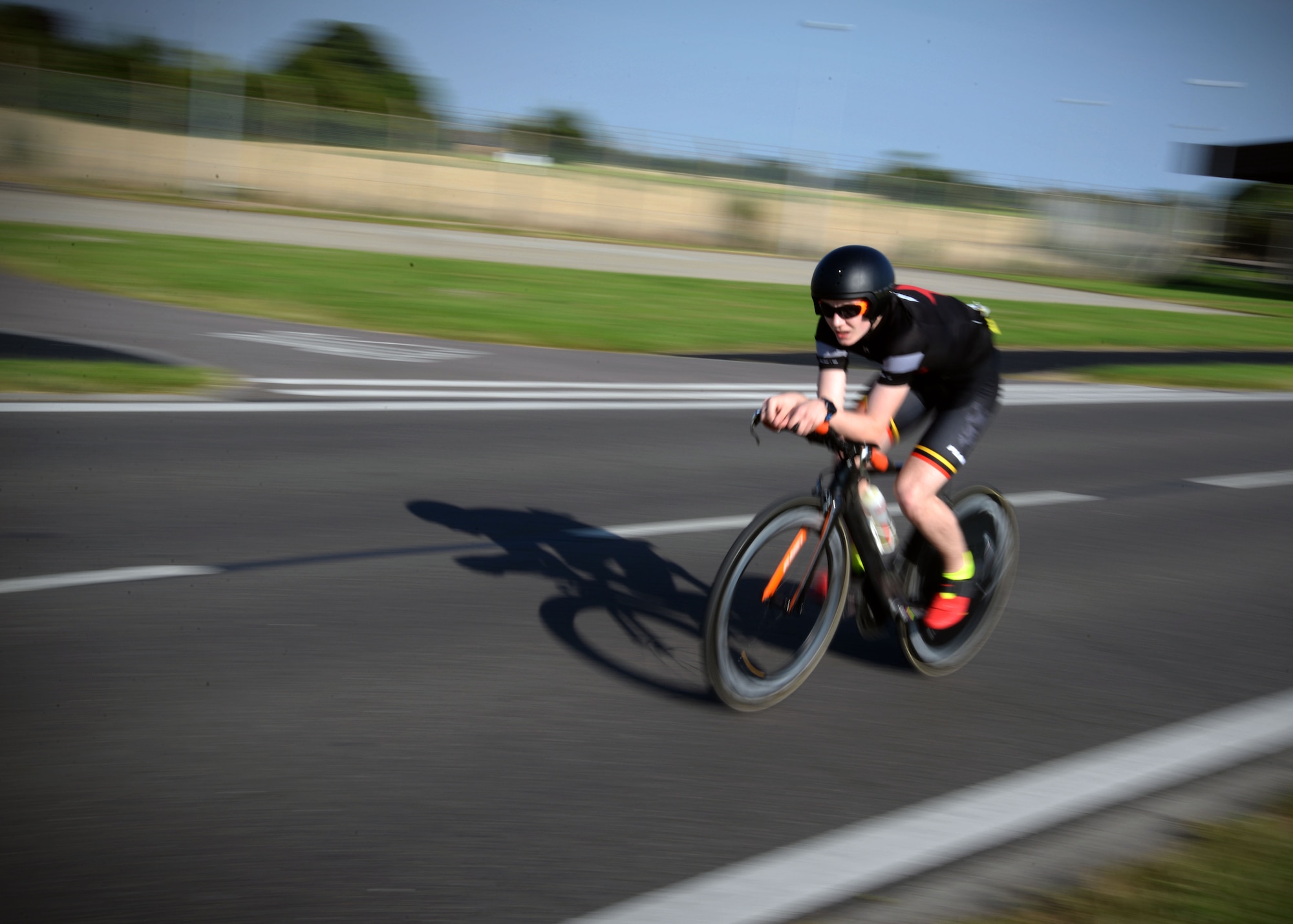 A participant of the RAF Mildenhall Fitness Center 3rd Annual Duathlon rides his bike July 23, 2016, on RAF Mildenhall, England. The duathlon is one of several events the fitness center hosts as a way to promote fitness and boost base-wide camaraderie. (U.S. Air Force photo by Senior Airman Christine Halan) 