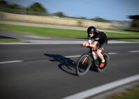 A participant of the RAF Mildenhall Fitness Center 3rd Annual Duathlon rides his bike July 23, 2016, on RAF Mildenhall, England. The duathlon is one of several events the fitness center hosts as a way to promote fitness and boost base-wide camaraderie. (U.S. Air Force photo by Senior Airman Christine Halan) 