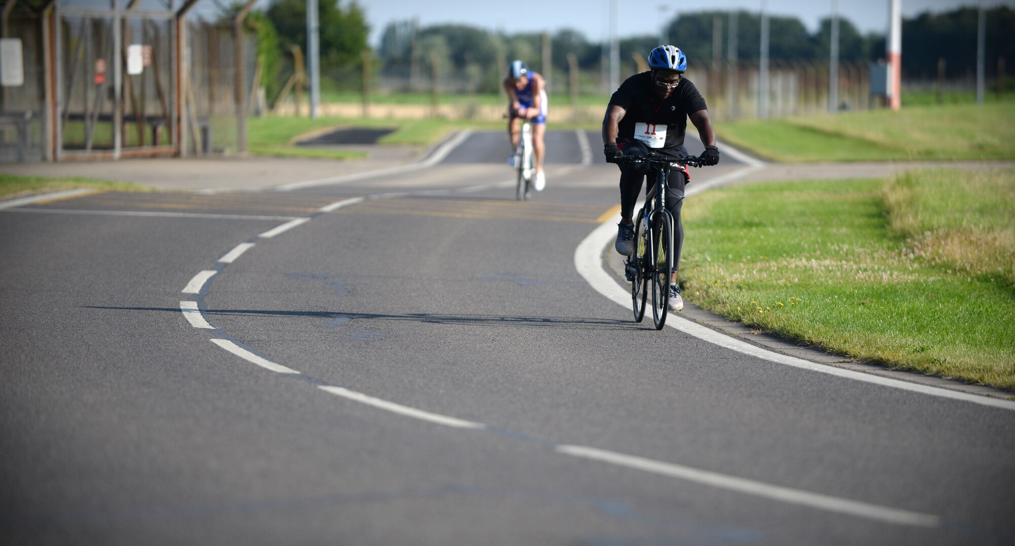 U.S. Air Force Tech. Sgt. Robert Wideman, 100th Logistics Readiness Squadron NCO in-charge of special purpose for vehicle maintenance, rides his bike July 23, 2016, during the RAF Mildenhall Fitness Center 3rd Annual Duathlon on RAF Mildenhall, England. The duathlon started with a two-mile run, followed by cycling 20 miles around the base perimeter, and finished with another two-mile run. (U.S. Air Force photo by Senior Airman Christine Halan)