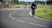 U.S. Air Force Tech. Sgt. Robert Wideman, 100th Logistics Readiness Squadron NCO in-charge of special purpose for vehicle maintenance, rides his bike July 23, 2016, during the RAF Mildenhall Fitness Center 3rd Annual Duathlon on RAF Mildenhall, England. The duathlon started with a two-mile run, followed by cycling 20 miles around the base perimeter, and finished with another two-mile run. (U.S. Air Force photo by Senior Airman Christine Halan)