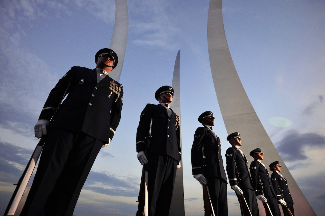 Airmen stand at attention before participating in ceremonial drill training at the Air Force Memorial in Arlington, Va., July 26, 2016. Air National Guard photo by Staff Sergeant Christopher S. Muncy