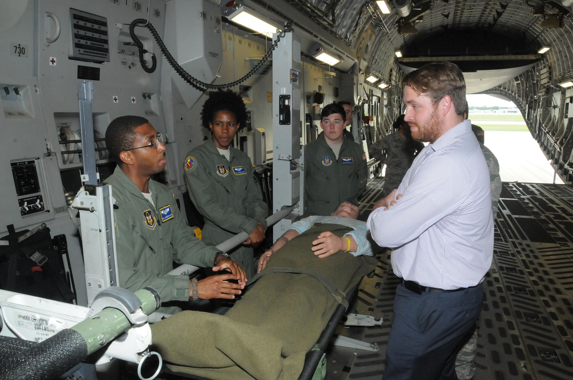 Senior Airman Lawrence Mark, 445th Aeromedical Evacuation Squadron AE technician, shares his experiences of serving in the unit to Geoff Daniels, Southwest Ohio Regional Representative for Senator Sherrod Brown, during Daniels’ visit to a 445th Airlift Wing C-17 Globemaster III July 26, 2016. Mark, along with Senior Airmen Aaliyah Lovett and Logan Wild, gave a demonstration of the various equipment AES uses on a day-to-day basis to perform their duty. Before stepping out to the aircraft Mr. Davis received a wing mission briefing and met with 445th Airmen. 