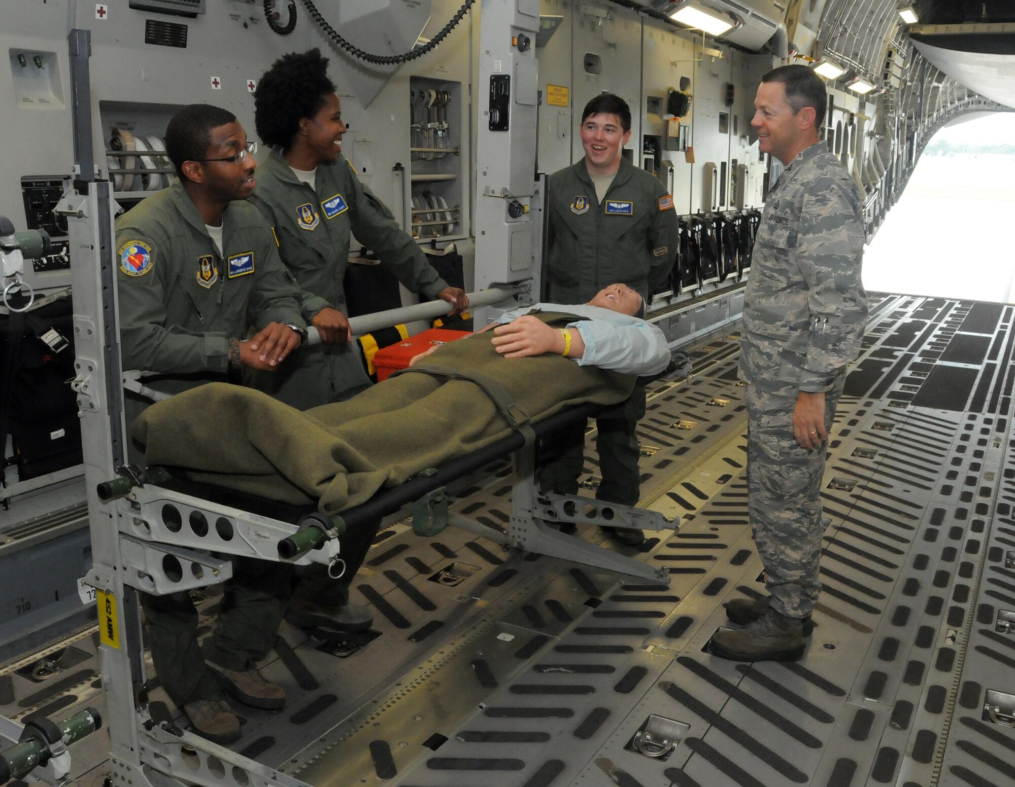 Col. Bradley McDonald, 88th Air Base Wing commander, visits with Senior Airmen Lawrence Mark, Aaliyah Lovett and Logan Wild, all assigned to the 445th Aeromedical Evacuation Squadron, while touring a 445th Airlift Wing C-17 Globemaster III July 26, 2016.  The AES Airmen gave a demonstration to Colonel McDonald of the various equipment they use on a day-to-day basis. Before stepping out to the aircraft Colonel McDonald received a wing mission briefing and met with 445th Airmen. (U.S. Air Force photo/Tech. Sgt. Anthony Springer)