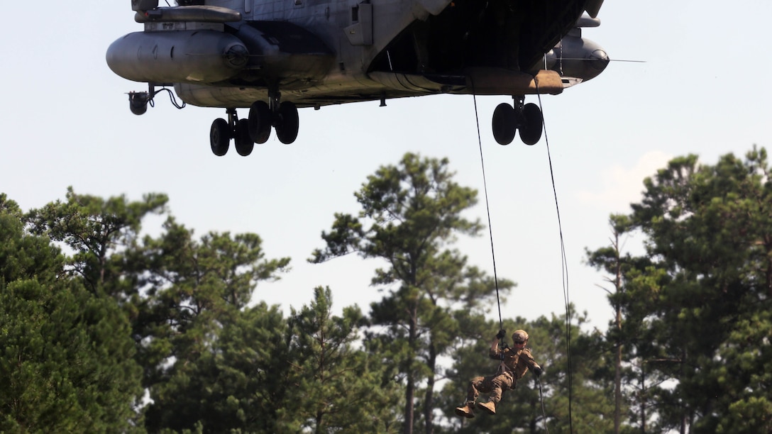 A Marine with U.S. Marine Corps Forces Special Operations Command rappels off the ramp of a CH-53E Super Stallion with Marine Heavy Helicopter Squadron 461 on Landing Zone Parrot at Marine Corps Base Camp Lejeune, N.C., July 20, 2016. The exercise was a part of a two weeklong Helicopter Insertion and Extraction Techniques Course. The CH-53 provided for the training evolution was assigned to Marine Heavy Helicopter Squadron 461, 2nd Marine Aircraft Wing. 