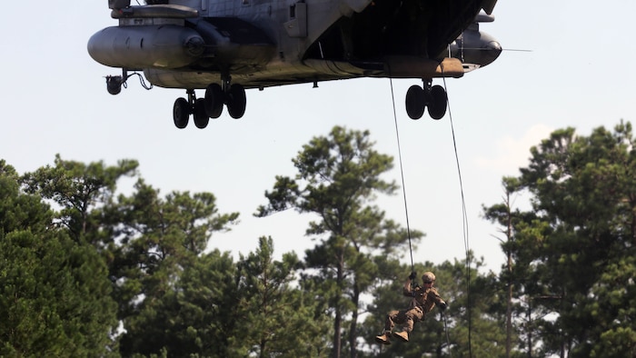 A Marine with U.S. Marine Corps Forces Special Operations Command rappels off the ramp of a CH-53E Super Stallion with Marine Heavy Helicopter Squadron 461 on Landing Zone Parrot at Marine Corps Base Camp Lejeune, N.C., July 20, 2016. The exercise was a part of a two weeklong Helicopter Insertion and Extraction Techniques Course. The CH-53 provided for the training evolution was assigned to Marine Heavy Helicopter Squadron 461, 2nd Marine Aircraft Wing. 