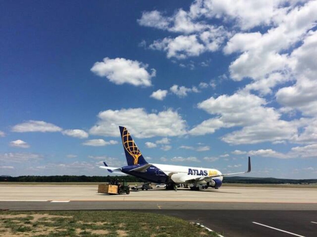 Dozens of troops from Westover Air Reserve Base head for Southwest Asia on a contract "rotator". The single-point pickup on base saved tens of thousands of dollars and allowed families to send off their loved ones.