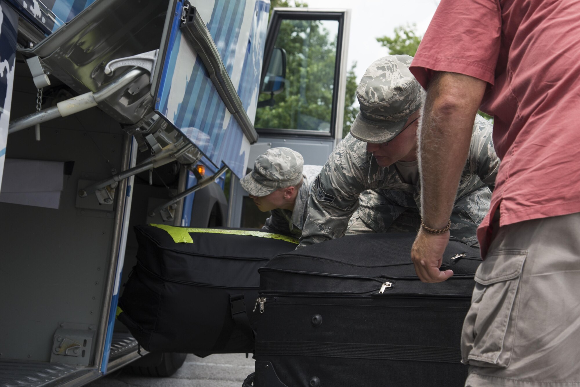 Team Scott members load their bags onto the bus as they prepare to deploy from Scott Air Force Base, Illinois. (U.S. Air Force photo by Airman 1st Class Gwendalyn Smith)