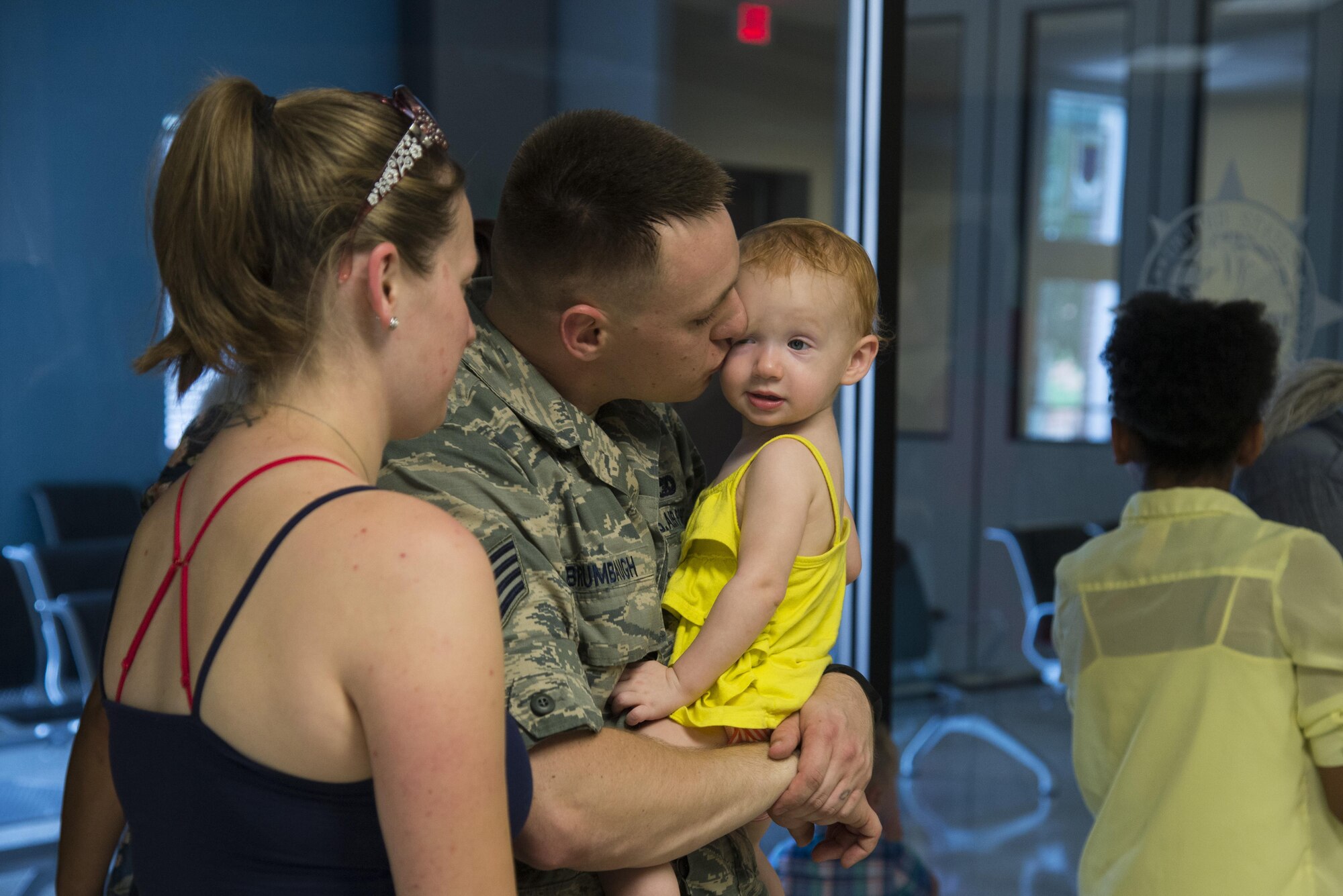 Staff Sgt. Kevin Brumbaugh, 375th Logistics Readiness Squadron Travel Management Office, says goodbye to his family before deploying from Scott Air Force Base, Illinois. (U.S. Air Force photo by Airman 1st Class Gwendalyn Smith)