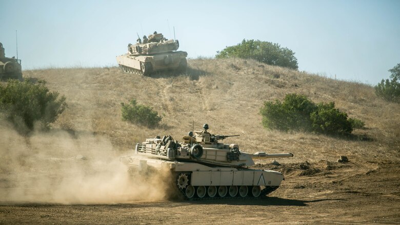 Marines with Company A, 4th Tank Battalion, 4th Marine Division, Marine Forces Reserve, assume their battle positions in M1A1 Abrams Main Battle Tanks during their annual training at Marine Corps Base Camp Pendleton, Calif., the day before their culminating event, July 21, 2016. The culminating event was comprised of both offensive and defensive operations against a notional adversary, where 4th Tank Bn. took the lead as the most heavily armored asset. During the event, the tanks formed screen lines, a stationary force that established a series of positions along a designated line to provide overlapping observation and lines of fire.