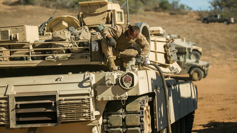 Marines with Company A, 4th Tank Battalion, 4th Marine Division, Marine Forces Reserve, refuel M1A1 Abrams Main Battle Tanks after their culminating event during their annual training at Marine Corps Base Camp Pendleton, Calif., July 22, 2016. The culminating event displayed the Marines ability to execute heavily armored, large scale attacks while working with their active duty counterparts.