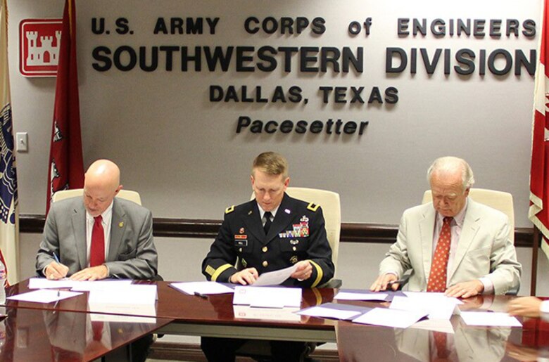 From left, Jeff Walker, Executive Administrator for the Texas Water Development Board; Brig. Gen. David C. Hill, Commander of the Southwestern Division, U.S. Army Corps of Engineers; and Ron Curry, Regional Administrator, Environmental Protection Agency Region 6; sign a Partnering Agreement in Dallas to improve intra-agency coordination for large Texas water supply projects.