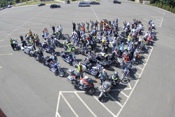 The Sister's Ride motorcyclists formed up in a chevron on July 5 in the Westover Club parking lot.