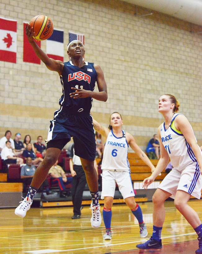 Army Sgt. Creshenda Singletary of Fort Bragg, N.C., hooks it over a French defender during Team USA's 85-53 win over France at the Conseil International du Sport Militaire Women's Basketball Championship tournament at Marine Corps Base Camp Pendleton, Calif., July 26, 2016. Army photo by Gary Sheftick
