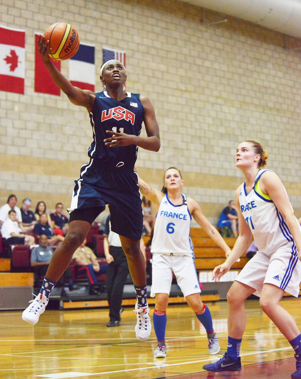 Army Sgt. Creshenda Singletary of Fort Bragg, N.C., hooks it over a French defender during Team USA's 85-53 win over France at the Conseil International du Sport Militaire Women's Basketball Championship tournament at Marine Corps Base Camp Pendleton, Calif., July 26, 2016. Army photo by Gary Sheftick