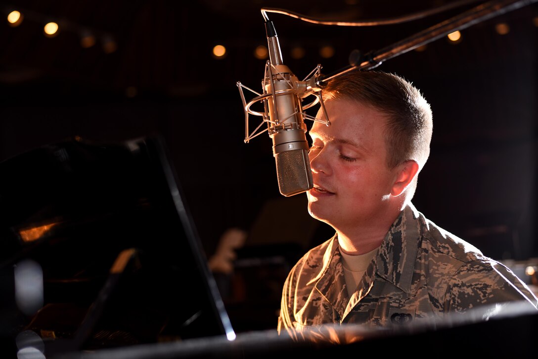 Airman 1st Class Jamie Teachenor, the U.S. Air Force Academy Band and Wild Blue Country lead vocalist, rehearses his songs at Peterson Air Force Base, Colo., July 20, 2016. Before joining the Air Force, Teachenor was a multi-platinum singer and songwriter based in Nashville, Tenn. (U.S. Air Force photo/Airman 1st Class Dennis Hoffman)       