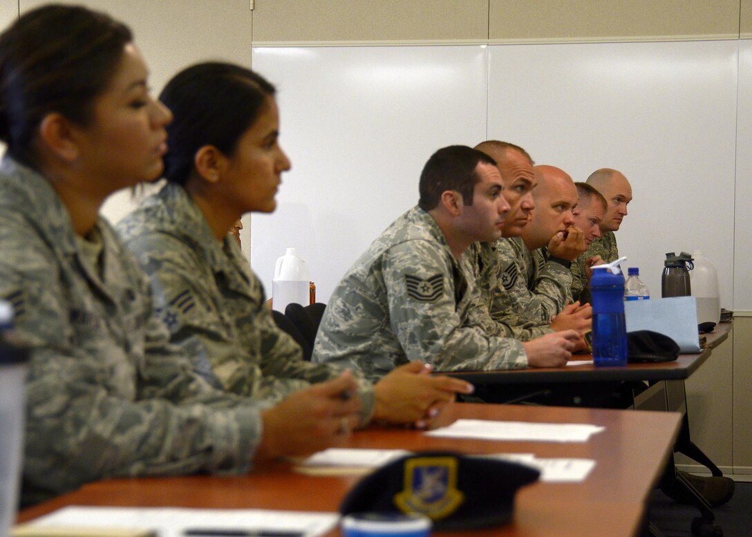 Members of the 445th Security Forces Squadron from the 445th Airlift Wing, Wright-Patterson Air Force Base, Ohio, sit in class alongside members of the 720th Security Forces Squadron, Davis-Monthan Air Force Base, Arizona, July 19, 2016, at Joint Base Elmendorf Richardson, Alaska. The reservists are completing initial training so that they may assist the home station 673rd Security Forces Squadron with guard duties and security at an upcoming air show. (U.S. Air Force photo/Senior Airman Joel McCullough)