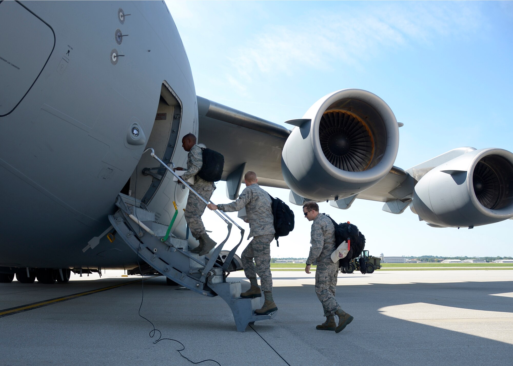 Members of the 445th Security Forces and Logistics Readiness Squadrons board a C-17 Globmaster III at Wright-Patterson Air Force Base, Ohio, July 17, 2016 for Joint Base Elmendorf Richardson, Alaska to complete their annual training. Members of the 445th SFS along with reservists from the 720th SFS out of Davis-Monthan Air Force Base, Arizona, helped to augment the home station SFS with guard duties and security duties for their end of July air show. The 445th LRS augmented the 673rd Logistics Readiness Squadron to them prepare their wing's vehicles for the end of July air show. (U.S. Air Force photo/Senior Airman Joel McCullough)
