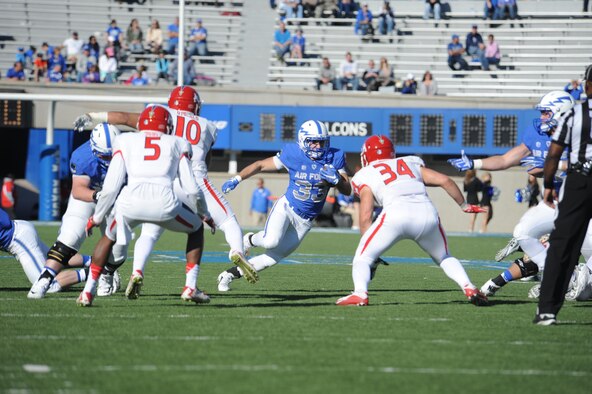 Junior running back Tim McVey makes a cut to avoid defenders in the Air Force-Fresno State game on Oct. 24, 2015. McVey emerged last season as a multi-dimensional threat, finishing third on the team in rushing and fourth in receiving, and racked up 887 all-purpose yards. In his first career start, he became the first player in Air Force history to have 100 yards rushing and receiving in the same game. (U.S. Air Force photo/John Van Winkle)