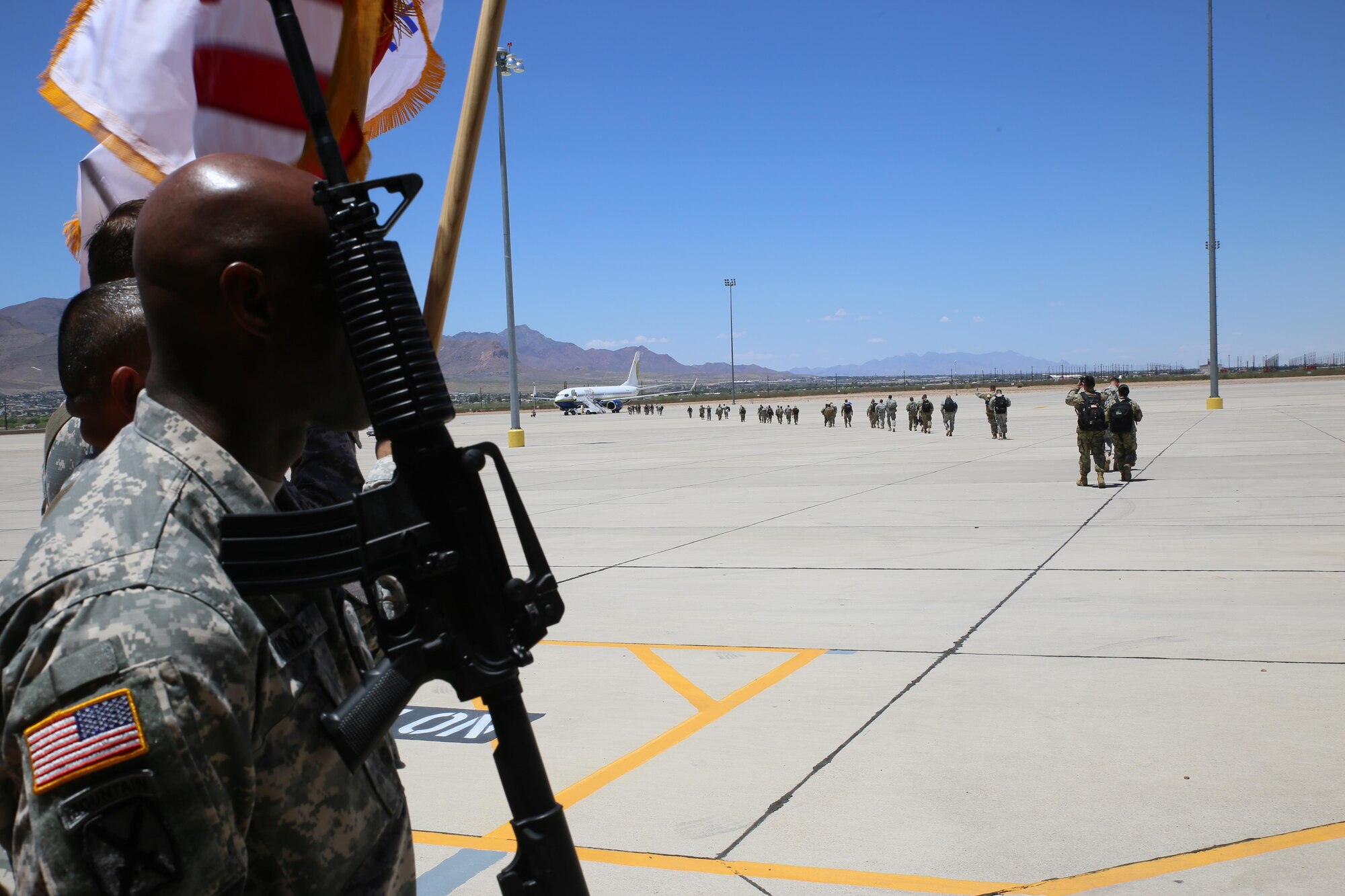 Soldiers assigned to the 544th Military Police Company, Puerto Rico Army National Guard, board a flight for a nine month deployment to Honduras July 11.